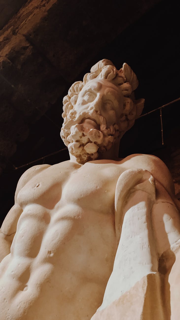 old sculpture of man with naked torso